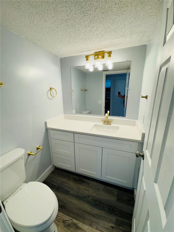 4100 Player Circle, Unit 101 Orlando, FL 32808 - Photo 14 of 34 a bathroom with a toilet a sink and mirror