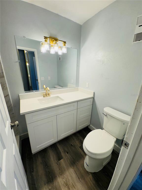 4100 Player Circle, Unit 101 Orlando, FL 32808 - Photo 29 of 34 a bathroom with a toilet a sink and mirror