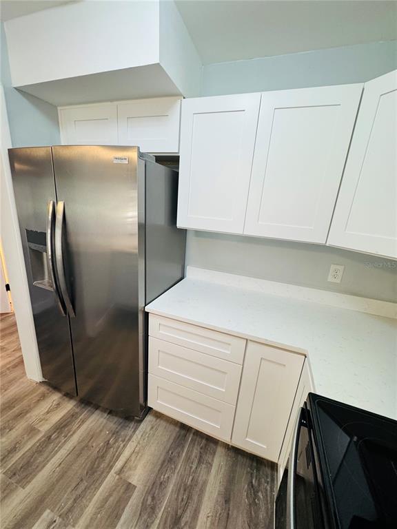 4100 Player Circle, Unit 101 Orlando, FL 32808 - Photo 5 of 34 a kitchen with a refrigerator sink and cabinets