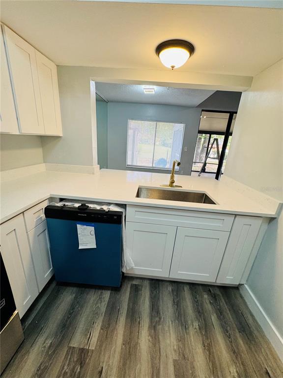 4100 Player Circle, Unit 101 Orlando, FL 32808 - Photo 8 of 34 a kitchen with granite countertop a sink and a stove top oven