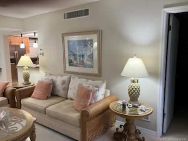 a living room with furniture and a lamp