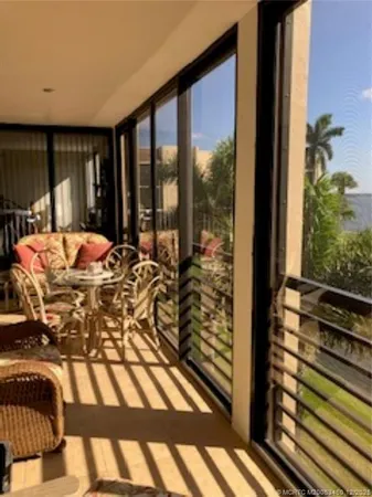 a view of a dining room with furniture and a chandelier