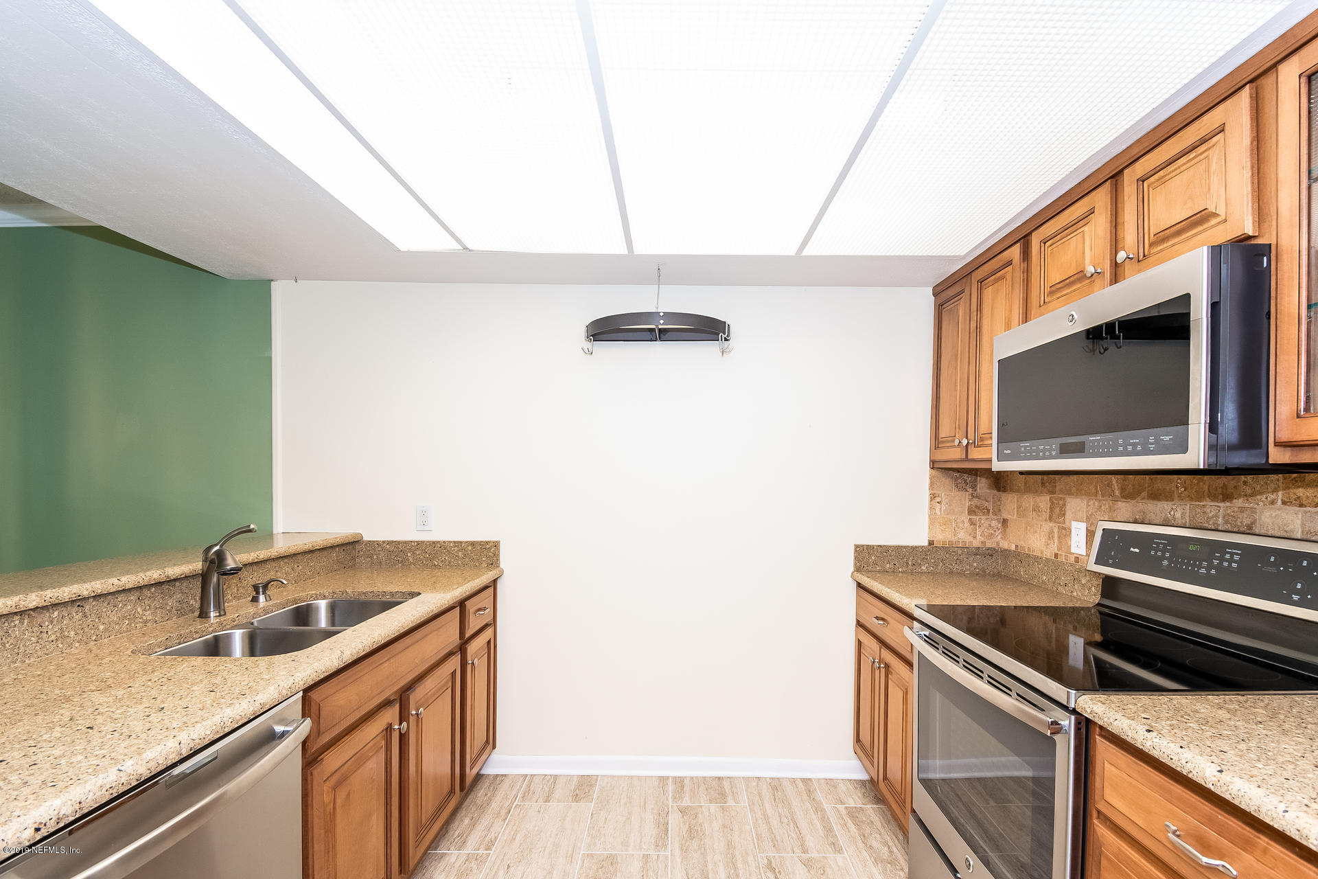 5478 Stanford Road Jacksonville, FL 32207 - Photo 13 of 26 a kitchen with a sink and a stove top oven