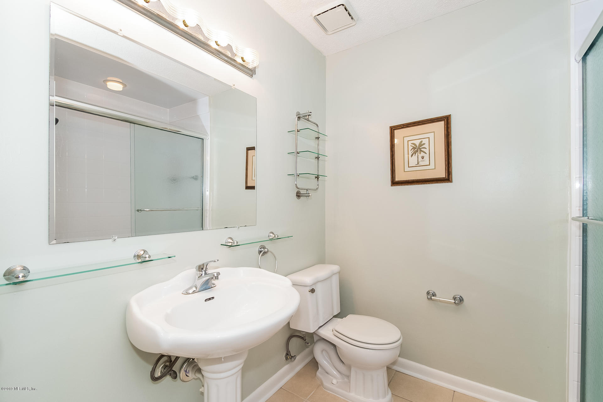 5478 Stanford Road Jacksonville, FL 32207 - Photo 16 of 26 a bathroom with a sink a mirror and a toilet
