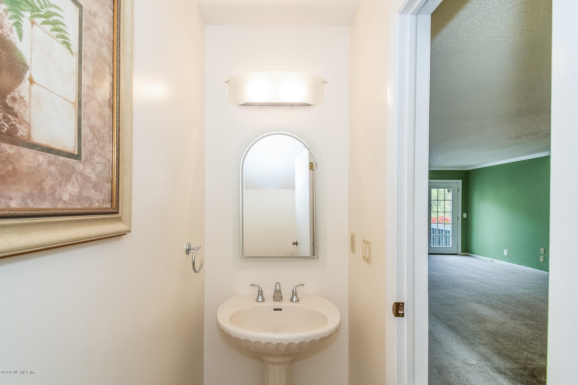 5478 Stanford Road Jacksonville, FL 32207 - Photo 20 of 26 a bathroom with a sink and a mirror
