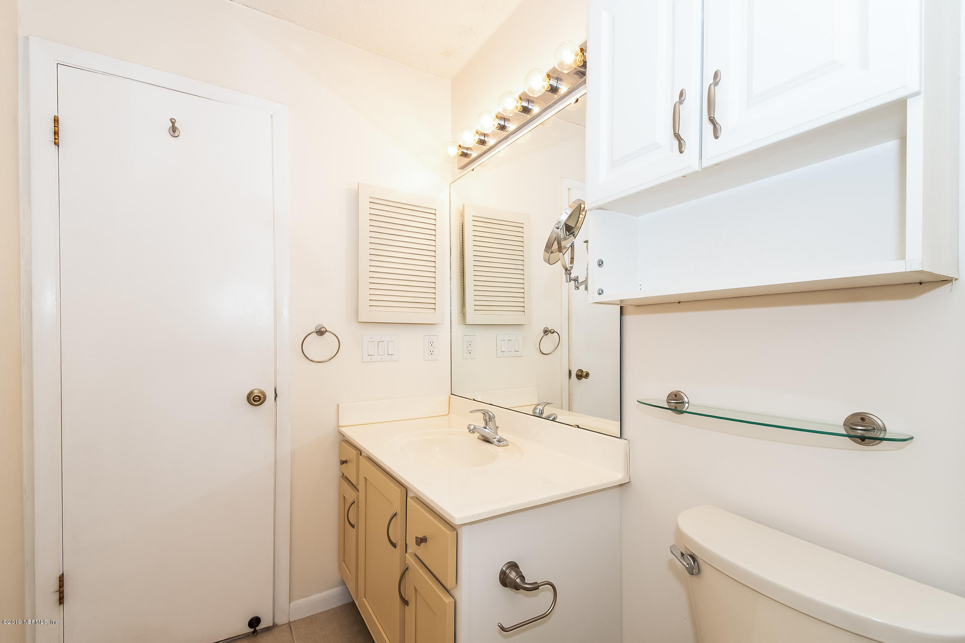 5478 Stanford Road Jacksonville, FL 32207 - Photo 22 of 26 a bathroom with a sink a toilet and shower