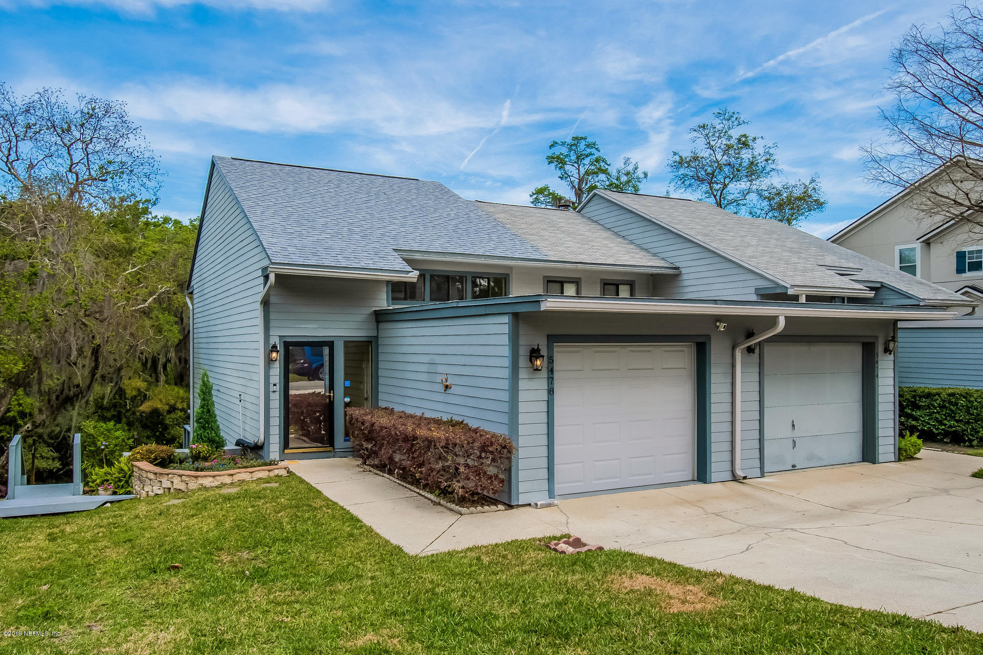 5478 Stanford Road Jacksonville, FL 32207 - Photo 25 of 26 a front view of a house with a yard and garage