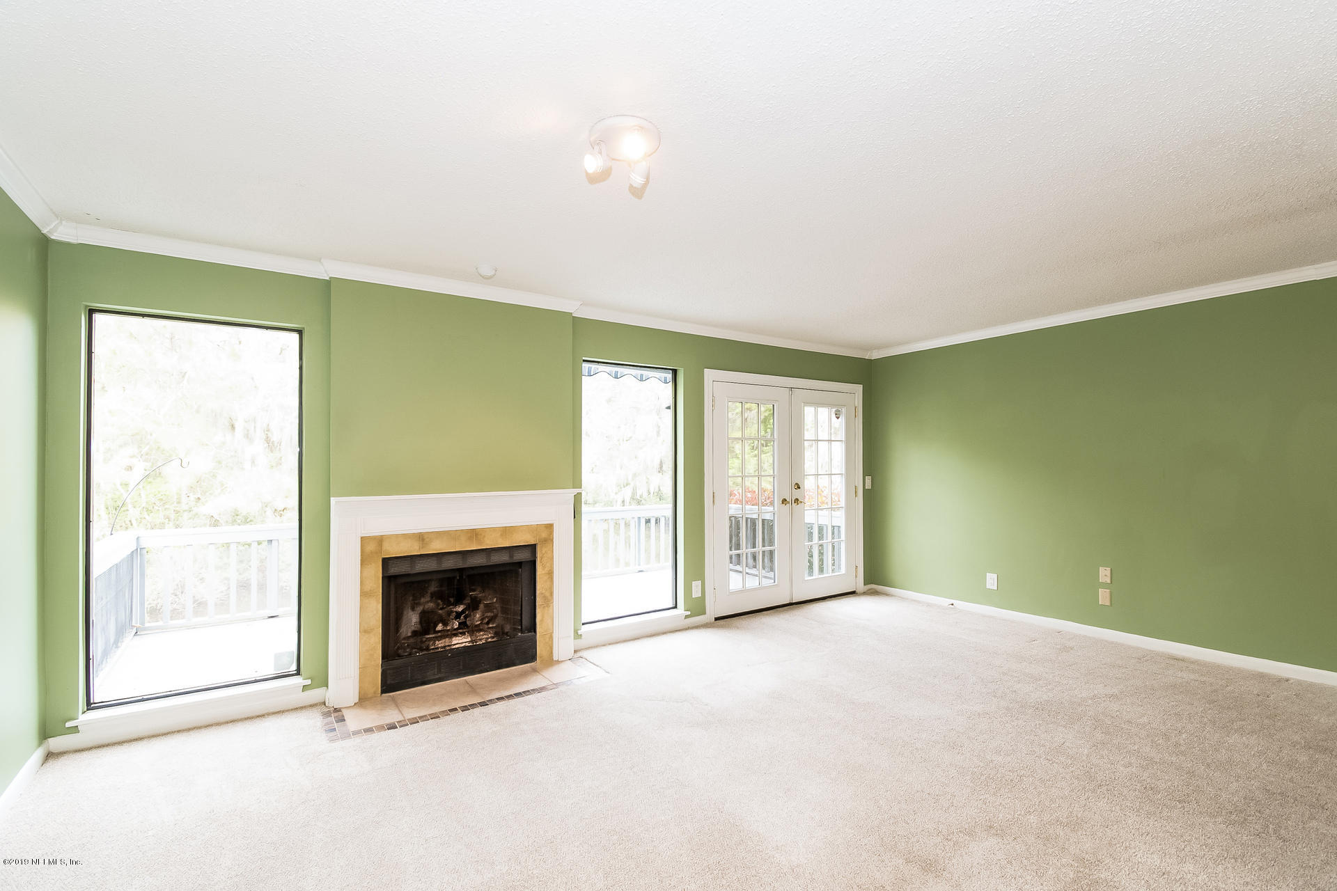5478 Stanford Road Jacksonville, FL 32207 - Photo 4 of 26 a view of an empty room with a fireplace and a window