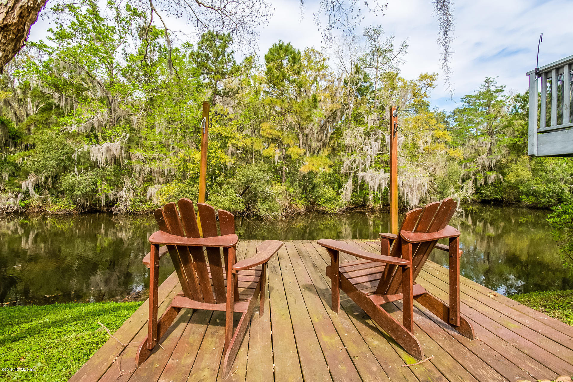 5478 Stanford Road Jacksonville, FL 32207 - Photo 6 of 26 a view of a chairs and table on wooden deck with lake view