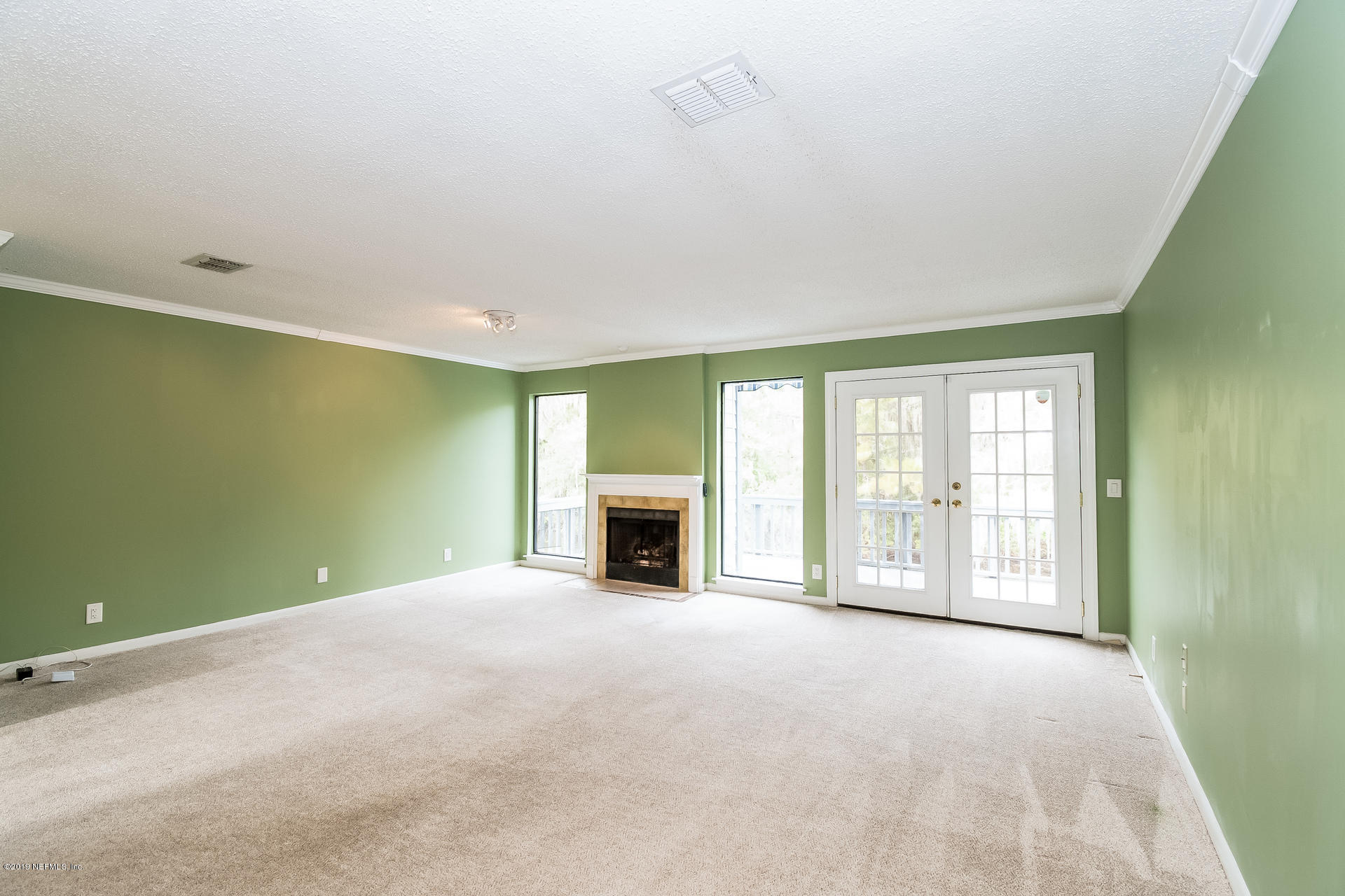 5478 Stanford Road Jacksonville, FL 32207 - Photo 8 of 26 a view of an empty room with a fireplace and a window