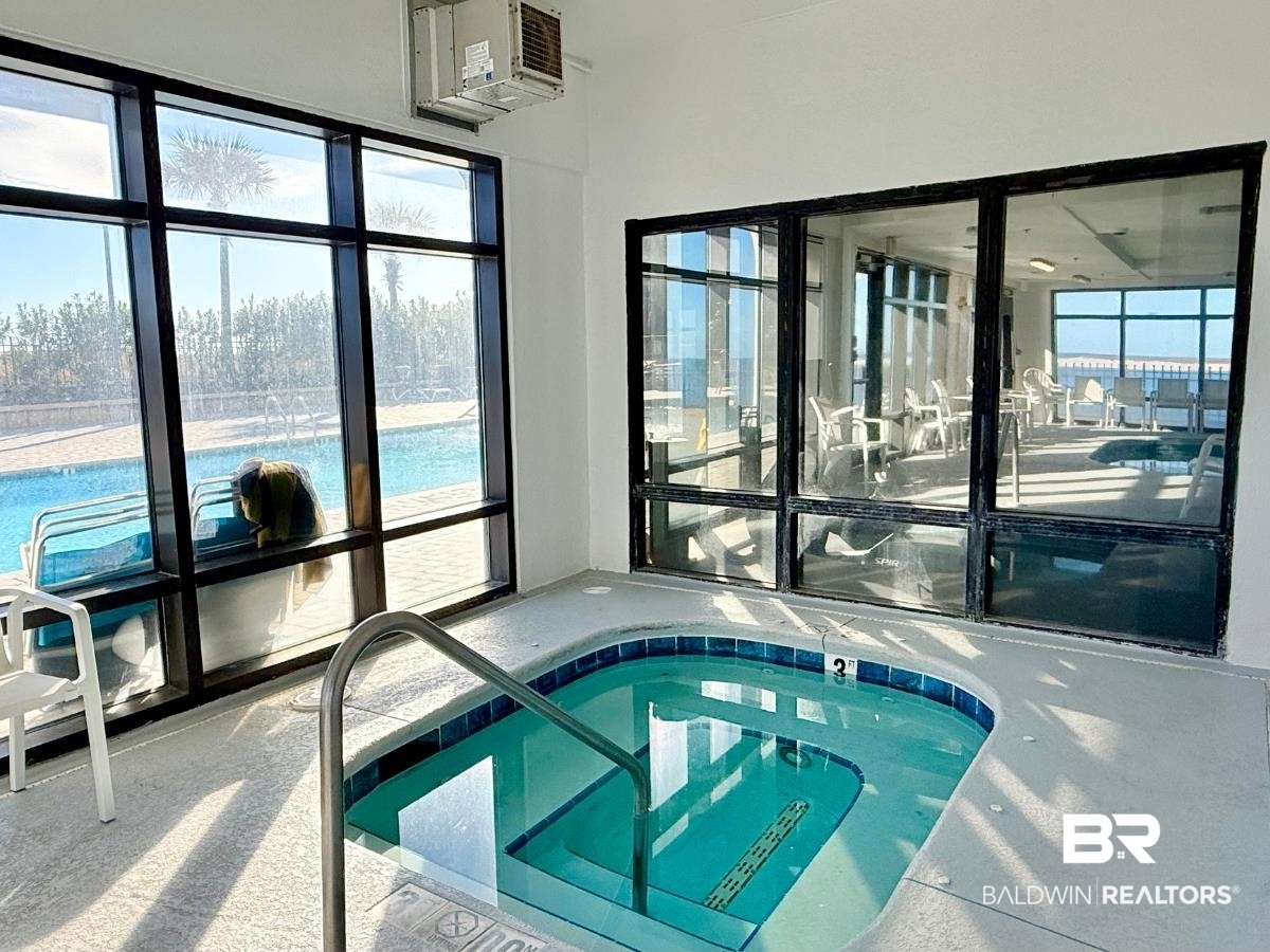 27284 Gulf Road, Unit 212 Orange Beach, AL 36561 - Photo 31 of 35 View of swimming pool featuring a hot tub and a sunroom