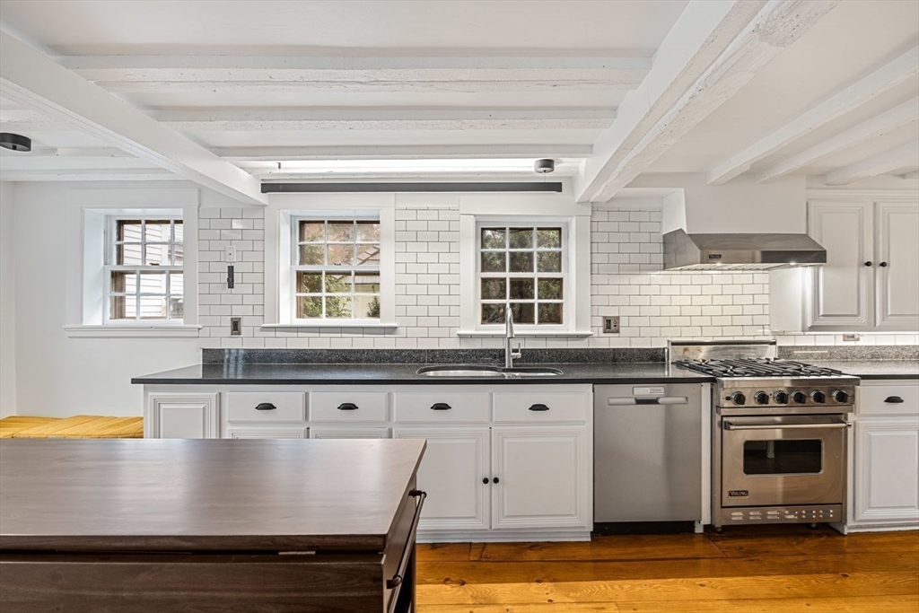 46 Church Street Dedham, MA 02026 - Photo 3 of 42 a kitchen with stainless steel appliances granite countertop a stove a sink and a microwave