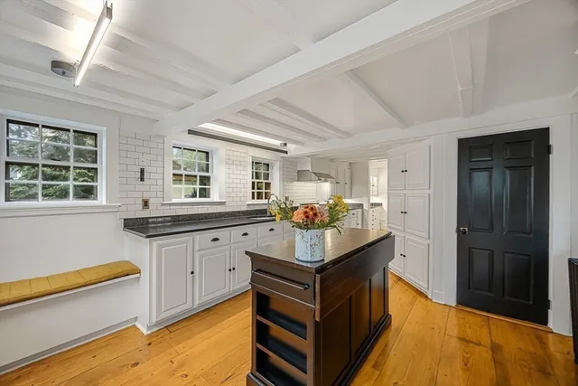 a kitchen with granite countertop a sink stove and refrigerator