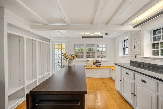 a large kitchen with granite countertop a sink and cabinets