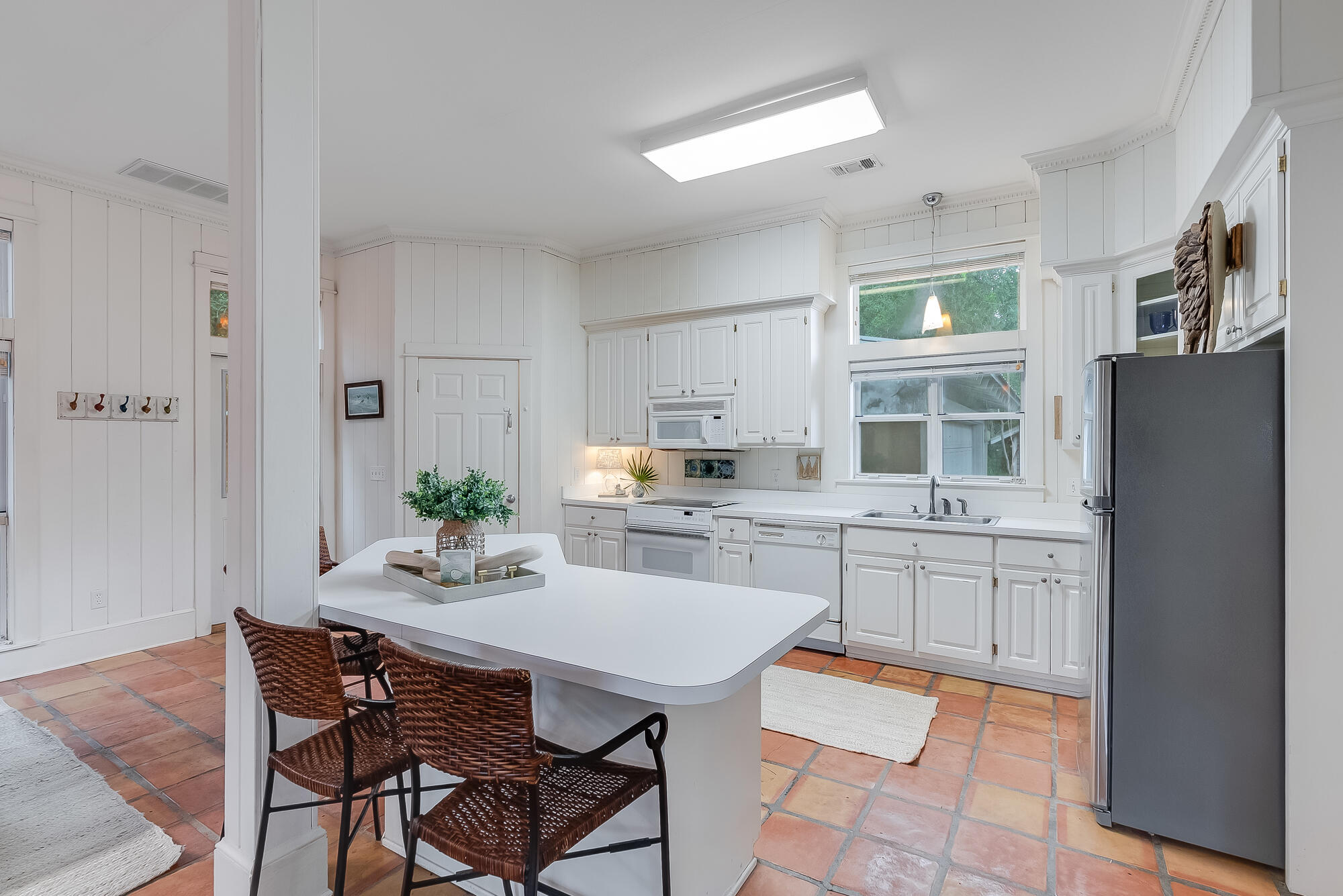 180 Wilderness Way Santa Rosa Beach, FL 32459 - Photo 7 of 69 a kitchen with stainless steel appliances kitchen island granite countertop a refrigerator a stove a sink dishwasher and white cabinets with wooden floor
