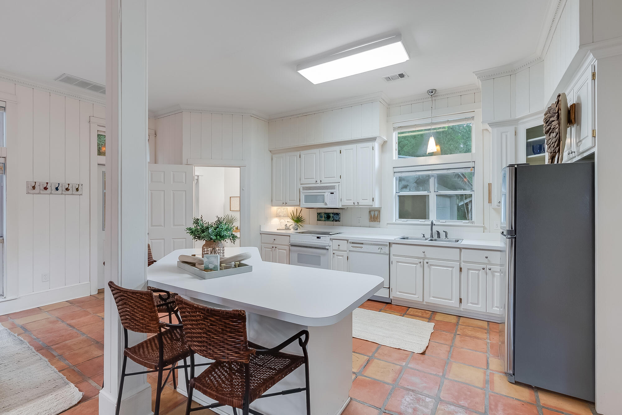 180 Wilderness Way Santa Rosa Beach, FL 32459 - Photo 8 of 69 a kitchen with a refrigerator a stove a sink dishwasher and white cabinets with wooden floor