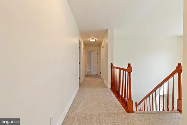 a view of a hallway with wooden floor and entryway