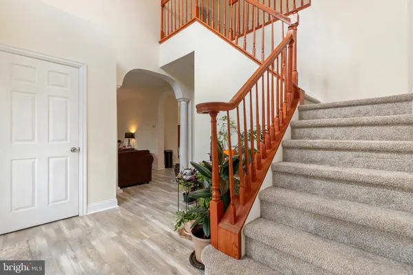 a view of entryway and hall with wooden floor