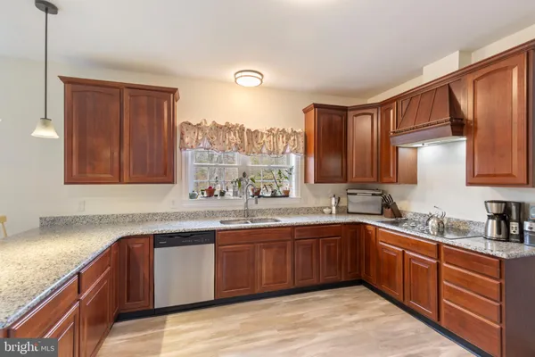 a kitchen with lots of counter top space sink and cabinets