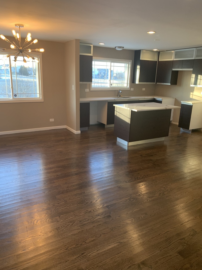 38 Wedgewood Road Matteson, IL 60443 - Photo 4 of 14 a kitchen with stainless steel appliances granite countertop a sink counter space and wooden floor