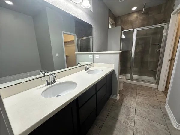 a bathroom with a sink double vanity and a mirror