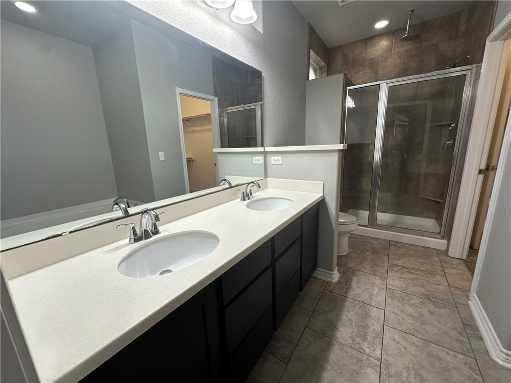 1015 Santa Catalina Street Portland, TX 78374 - Photo 12 of 34 a bathroom with a sink double vanity and a mirror