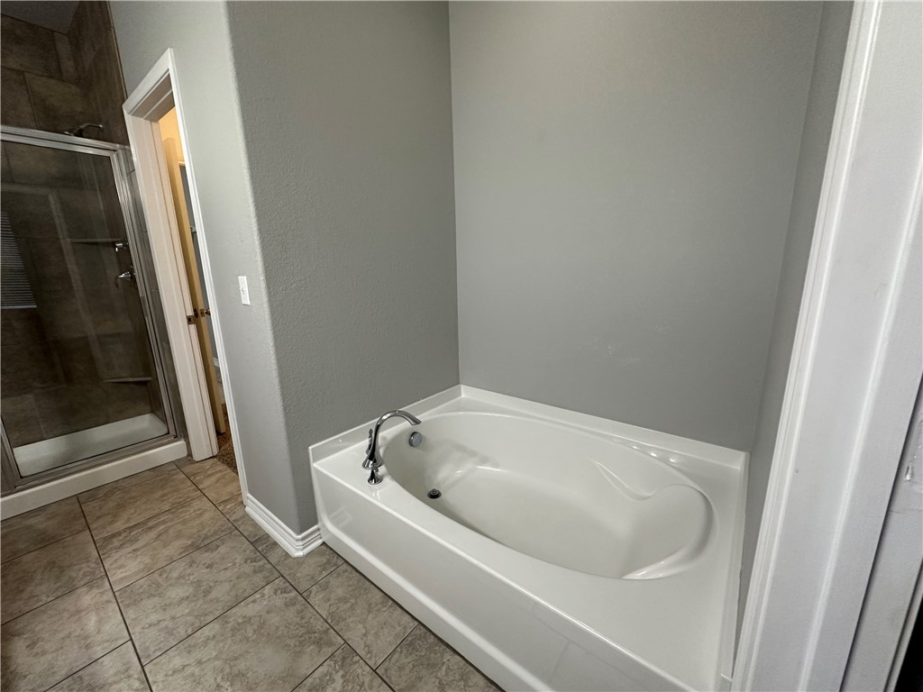 1015 Santa Catalina Street Portland, TX 78374 - Photo 13 of 34 a white bath tub sitting next to a white sink and vanity
