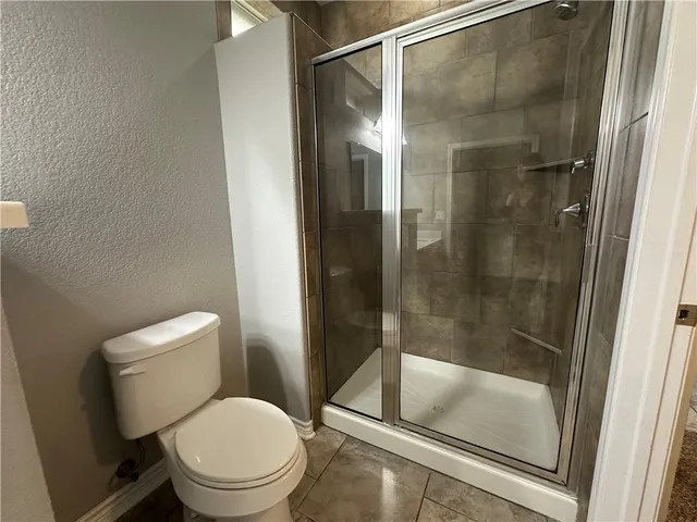 a bathroom with a shower and toilet