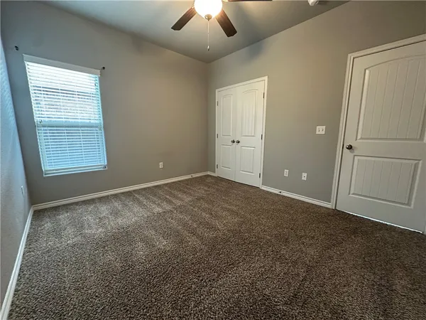 en empty room with windows and closet