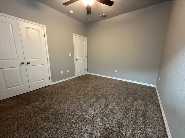 an empty room with closet area