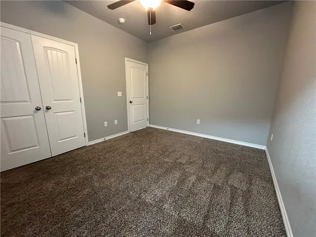 an empty room with closet area