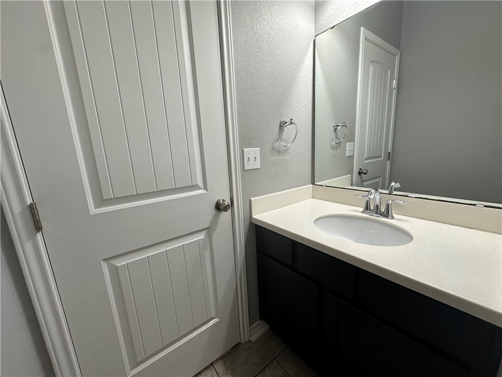 1015 Santa Catalina Street Portland, TX 78374 - Photo 24 of 34 a bathroom with a sink and a mirror
