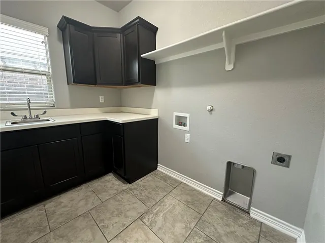 a kitchen with a sink and cabinets