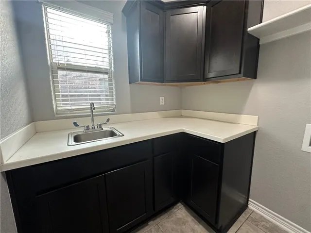 a kitchen with a sink and cabinets