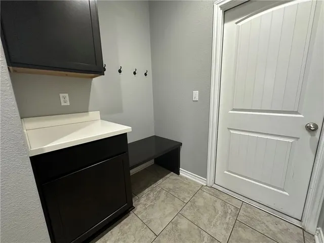 a kitchen with a sink and a refrigerator