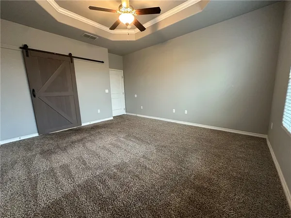 en empty room with windows and fan