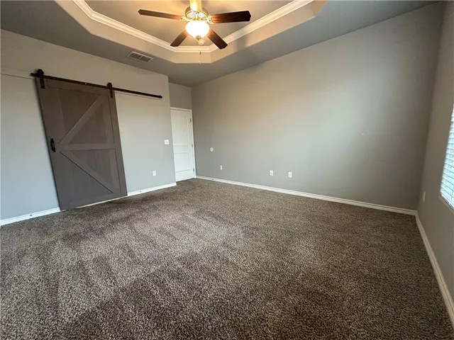 en empty room with windows and fan