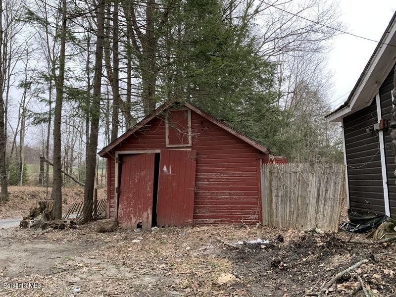 164 Heath Road Colrain, MA 01340 - Photo 9 of 18 a view of barn with wooden fence and large trees