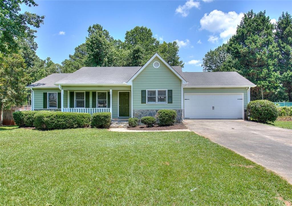 1631 Plunketts Road Buford, GA 30519 - Photo 1 of 1 a front view of a house with a garden