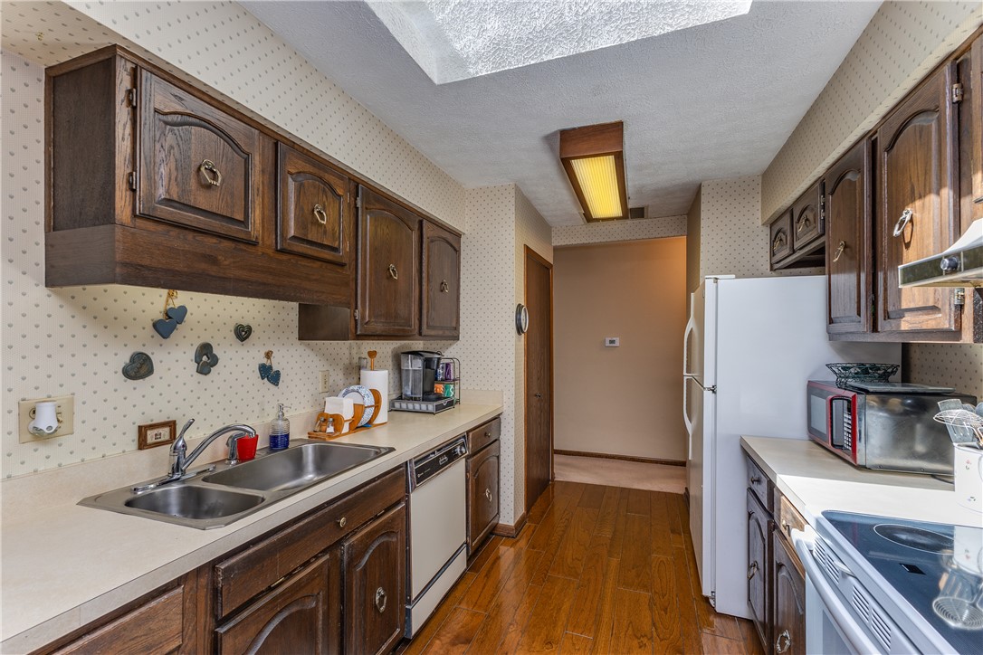 4210 Pleasanton Road Englewood, OH 45322 - Photo 9 of 34 This galley kitchen features ample cabinetry and a bright overhead skylight.