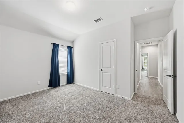 a view of an empty room and closet area