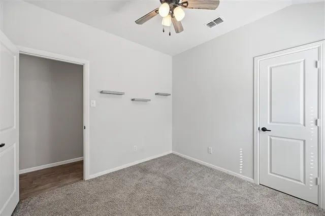 a view of an empty room with a chandelier