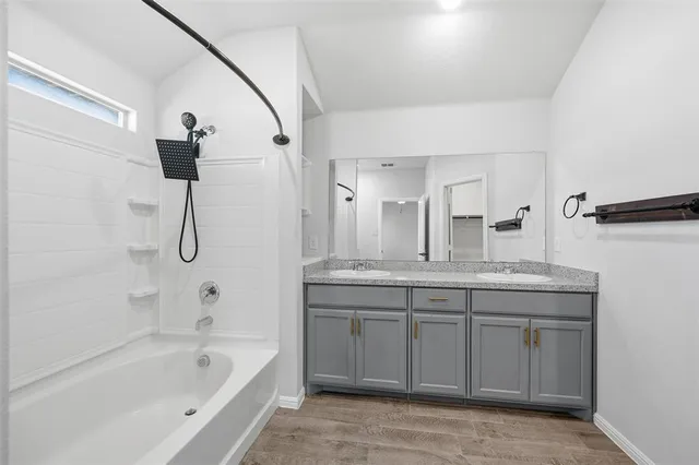a bathroom with a granite countertop sink a toilet and bathtub