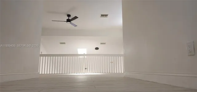 a view of a room with wooden floor