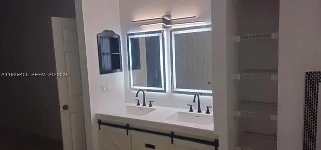 a bathroom with a sink and a mirror