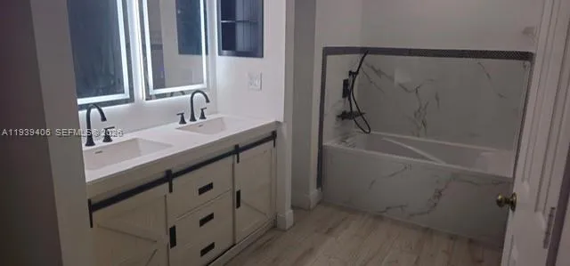 a bathroom with a sink a mirror and a shower