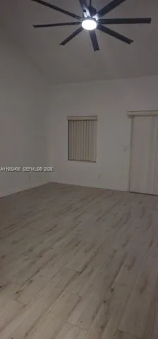 a view of an empty room with a fan