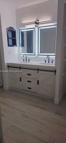a bathroom with a sink and a mirror
