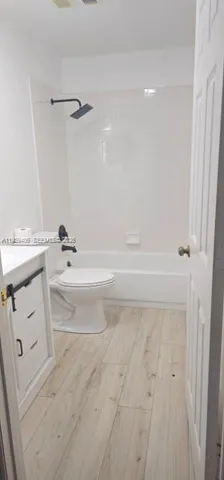 a bathroom with a bathtub a sink a toilet and a shower