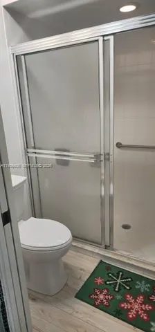 a bathroom with a toilet and a shower